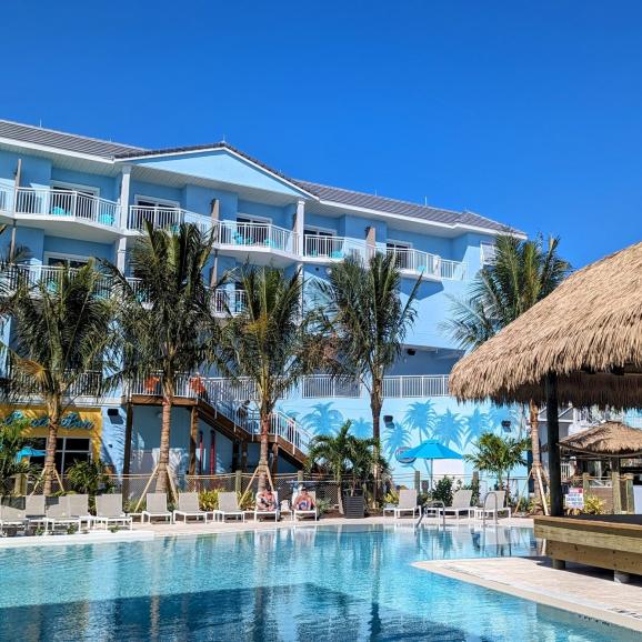 Margaritaville Pool with Palm trees by tiki hut