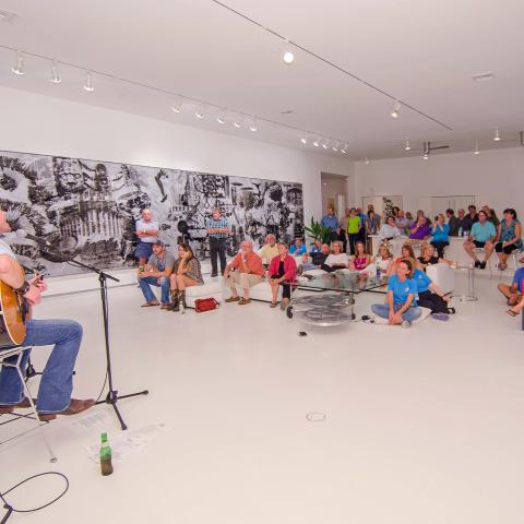 Two performers sing at an exclusive event at the home of artist Robert Rauchenberg.